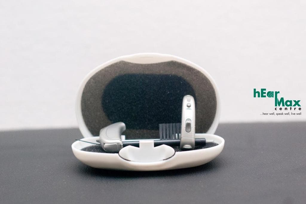 Behind-the-ear hearing aid in its case