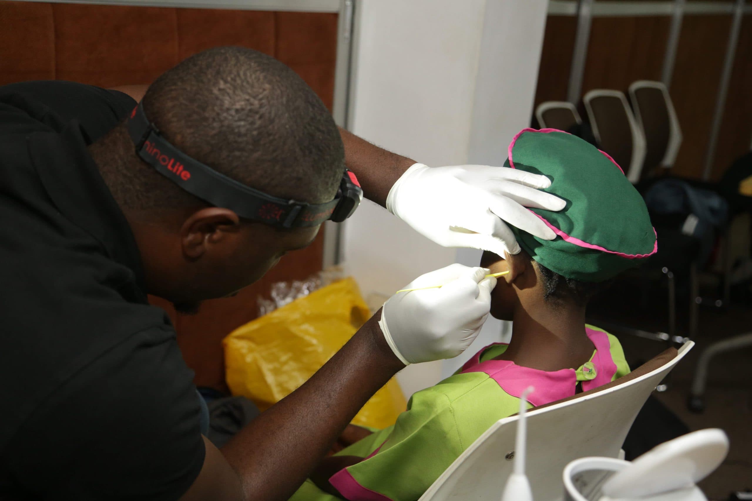Audiologist performing a hearing test on a client in Nigeria