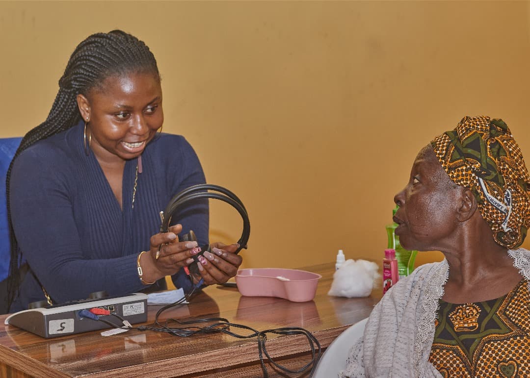 Audiologist fitting testing headphones on a client at HearMax Centre